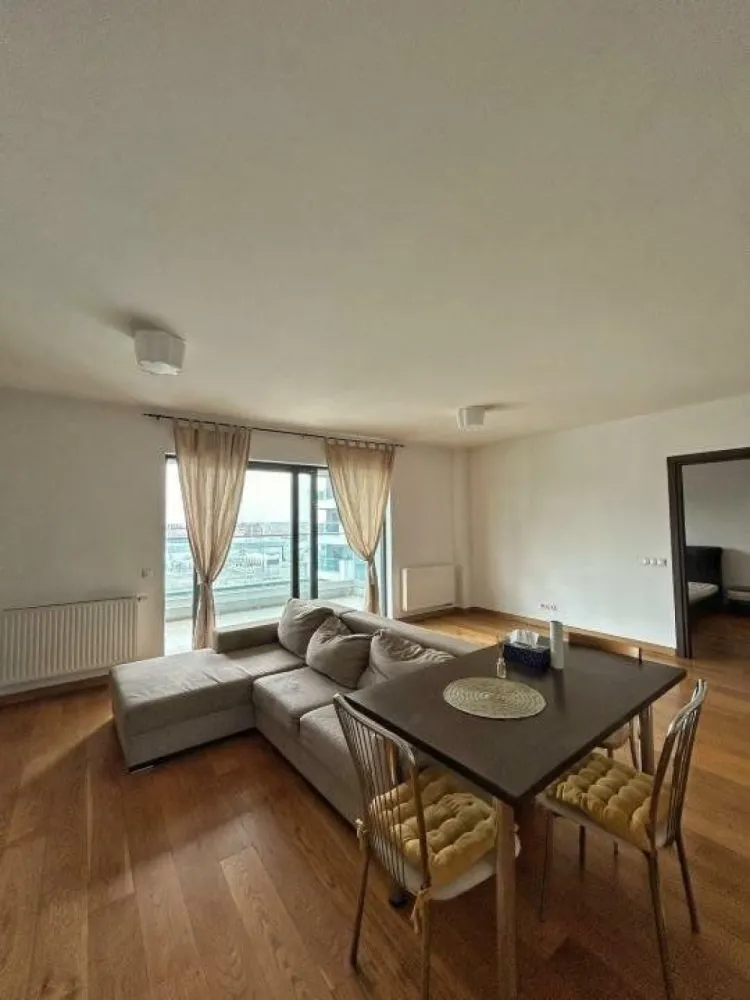 Apartament cu 2 camere - de inchiriat in Upgroun Residence - Direct de la proprietar si fara niciun comision, va oferim spre inchiriere acest apartament modern de 2 camere, situat in complexul Upground Residence, disponibil complet mobilat, cu multiple spatii de depozitare, o bucatarie complet utilata, 1 balcon, 2 bai si dormitor. Apartamentul are un generos si luminos living de tip open space de pe care se poate iesi pe balcon, bucataria este complet mobilata si utilata, iar dormitorul complet mobilat va va asigura tot confortul, fiind dotat cu baie proprie. Apartamentul este dotat cu centrala termica, aer conditionat, masina de spalat vase incorporata si masina de spalat rufe, astfel incat confortul tau sa fie asigurat! La parterul complexului Upground puteţi găsi tot ce aveţi nevoie, de la magazine alimentare, cafenele, saloane de înfrumuseţare, până la o sală de gimnastică de clasă mondială şi un studio de yoga. La 5 minute de mers pe jos de apartament ajungeţi la staţia de metrou Pipera şi la staţiile de tramvai care vă ajută să vă conectaţi cu restul oraşului. Promenada Mall este, de asemenea, la doar câteva minute de mers pe jos de complex. Sunt disponibile şi locuri de parcare în garajul subteran şi pot fi închiriate separat. Directly from the owner and without any commission, we offer for rent this modern 2-room apartment, located in the Upground Residence complex, available fully furnished, with multiple storage spaces, a fully equipped kitchen, 1 balcony, 2 bathrooms and a bedroom. The apartment has a generous and bright open space living room from which you can exit to the balcony, the kitchen is fully furnished and equipped, and the fully furnished bedroom will ensure all the comfort, being equipped with its own bathroom. The apartment is equipped with central heating, air conditioning, built-in dishwasher and washing machine, so that your comfort is ensured! On the ground floor of the Upground complex you can find everything you need, from grocery stores, cafes, beauty salons, to a world-class gym and a yoga studio. A 5-minute walk from the apartment you reach the Pipera metro station and tram stops that help you connect with the rest of the city. Promenada Mall is also just a few minutes walk from the complex. Parking spaces are also available in the underground garage and can be rented separately.
