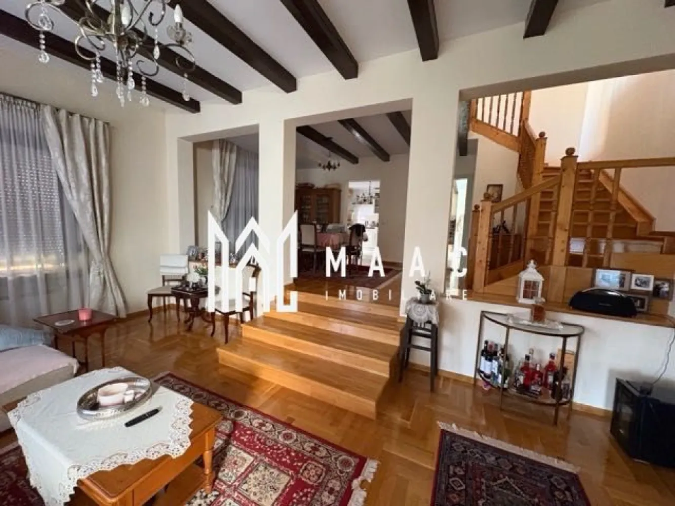 Casa Individuala | 200 Mp | 4 Camere | Calea Poplăcii - MAAC Imobiliare vă propune spre vânzare o casă individuală elegantă, situată într-o zonă deosebit de liniștită și apreciată — Calea Poplăcii, în vecinătatea exclusivistă de case. Caracteristici generale: -Suprafață utilă: 200 mp (parter + etaj) -Demisol: 80 mp -Teren generos: 450 mp cu grădină și curte amenajată -Acces auto, terasă acoperită și protejată Demisol (80 mp) -Spațiu tehnic -Bucătărie -Baie de serviciu -Pivniță Parter (100 mp) -Hol generos cu spațiu dedicat biroului -Living primitor cu șemineu -Zonă de dining Bucătărie separată -Baie de serviciu Etaj (100 mp) Zonă de relaxare / timp liber -3 dormitoare -Baie spațioasă -Dressing și spațiu de depozitare suplimentar -Din etaj există acces către podul utilizabil, ideal ca spațiu de depozitare. Exterior: -Curte frumos amenajată cu zonă verde -Terasă acoperită, perfectă pentru momente de relaxare în aer liber -Acces auto în curte -Casa este bine întreținută, nu necesită renovări sau reparații majore și este echipată cu panouri solare (7 kW) pentru eficiență energetică și costuri reduse. 📞 Pentru mai multe detalii, vă rugăm să ne contactați specificând ID: CP2650265 }}