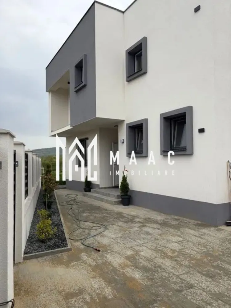 Casa individuala 4 Camere | Teren 350 MP | Terasa | Bungard - MAAC Imobiliare vă prezintă spre vânzare o casă unifamilială, situată la doar 7 km de centrul Sibiu, în localitatea Bungard, pe stradă asfaltată.

Caracteristici:
Construcție începută în 2025, cu termen de predare iunie 2026
Predare la stadiul de cheie la exterior și gri avansat la interior, oferind libertatea amenajării după propriul gust
Suprafață utilă: 186 mp
Suprafață teren total: 350 mp
Amprenta: 120 mp
Curte amenajată cu dale și spațiu verde
2 locuri de parcare în curte

Compartimentare:
Parter
Hol de acces
Living spațios
Bucătărie
Baie
Cameră tehnică sau spațiu de depozitare
Casa scării
Terasă acoperită generoasă de 40 mp

Etaj
Hol
3 dormitoare, dintre care dormitorul matrimonial beneficiază de baie proprie și dressing
Baie
Balcon

Dotări și calitate construcție:
Izolație exterioară cu polistiren de 15 cm
Încălzire în pardoseală atât la parter, cât și la etaj
Centrală termică Ariston de 30 kW
Tâmplărie PVC Salamander cu 3 foi de sticlă, pentru un confort termic și fonic ridicat
Construcție realizată cu materiale de calitate superioară

Utilități:
Gaz
Curent electric
Apă
Canalizare

Avantaje:
Locație liniștită, la doar câteva minute de oraș
Ideală pentru o familie care își dorește confort, spațiu și intimitate.

Pentru mai multe detalii specificati telefonic ca ati vazut anuntul cu ID: CP3063775