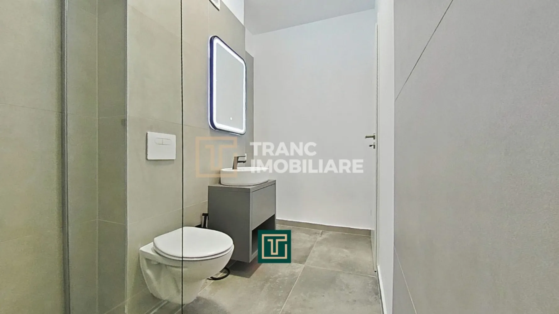 Apartament cu 2 camere într-un bloc nou, Via Carmina – Vladimirescu - Comisionul pentru cumpărător este 0%!

Îți prezentăm spre vânzare un apartament modern cu 2 camere, situat în cadrul proiectului rezidențial Via Carmina din Vladimirescu, una dintre cele mai apreciate zone rezidențiale din județul Arad. Amplasat într-un cartier liniștit, cu acces rapid către oraș și facilități moderne în apropiere, acest apartament este alegerea ideală pentru locuire sau investiție.

Imobilul a fost finalizat în anul 2024, iar apartamentul este poziționat la etajul 1 al unui bloc cu 3 etaje, dotat cu lift. Locuința are o suprafață utilă de aproximativ 53 mp și o suprafață construită de 64 mp, fiind compartimentată semidecomandat: dormitor, living, bucătărie, baie. Bucătăria open-space, integrată armonios cu zona de zi, oferă un spațiu luminos și funcțional, perfect pentru confortul zilnic.

Apartamentul beneficiază de finisaje premium, precum parchet, gresie și vopsea lavabilă de calitate superioară. Confortul termic este asigurat de centrala termică proprie pe gaz și sistemul de încălzire prin pardoseală, iar pentru siguranță și eficiență energetică imobilul este bine izolat și dotat cu videointerfon. Locuința se predă cu bucătăria complet mobilată și utilată, aer condiționat cu accesare la distanță și centrală pe gaz.

Zona este complet amenajată, cu drumuri asfaltate și iluminat stradal, oferind un cadru sigur și plăcut. Prețul nu include TVA 21% și locul de parcare.