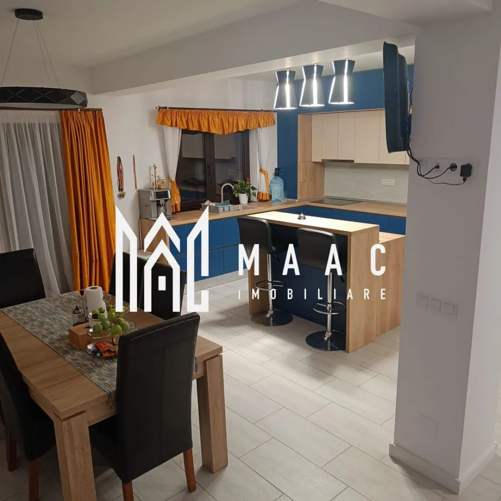 Casa 4 camere | Curte proprie | Panouri solare | Sura Mica - MAAC Imobiliare propune spre vanzare un duplex situat in Sura Mica. Suprafata totala teren: 200mp Suprafata utila: 115 mp (57,5 mp per nivel) Constructie 2021 Parter tip open space: living generos cu semineu, spatiu de servit masa (dining), bucatarie cu insula, complet utilata, camara, baie cu cabina de dus si geam de aerisire. Etaj: 2 dormitoare cu balcon fiecare, 1 dormitor utilat ca si office space, baie cu geam de aerisire si cada, debara. Exterior: terasa exterioara mobilata la parter, spatiu de parcare pentru 2 masini, gratar generos din fier cu spatiu de lucru, jacuzzi, pivnita. Casa este racordata la toate utilitatile, se vinde complet mobilata si utilata ( electrocasnice: aragaz, aspirator, cafetiera, cuptor cu microunde, fier de calcat, frigider, hota, masina de spalat rufe, masina de spalat vase, robot bucatarie, sandwich-maker, toaster, TV). Panouri solare 3 Kw montate 2024. Pentru mai multe detalii precizati telefonic ca ati vazut anuntul cu ID: CP2103454 }}