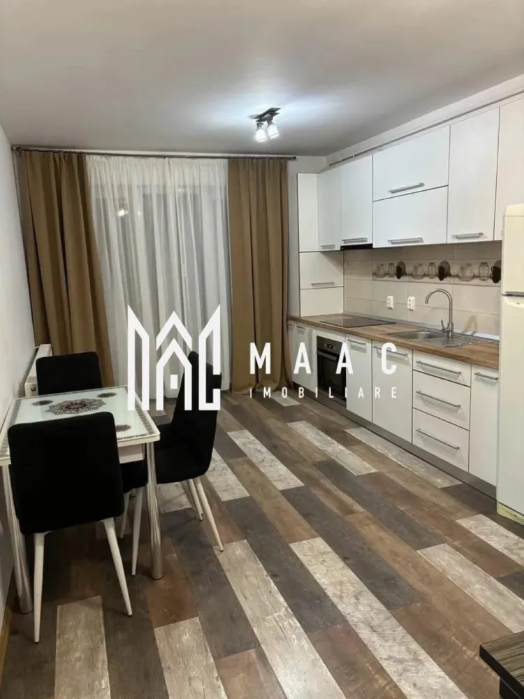 Apartament 2 camere | 40MPU | Balcon | City Residence - MAAC vă propune spre închiriere un apartament modern cu 2 camere, situat în zona City Residence, la doar 15 minute de mers pe jos de centrul orașului Sibiu.

Poziționat la parter înalt într-un imobil construit în 2018, apartamentul are o suprafață utilă de 40 mp și este compartimentat eficient, oferind un spațiu confortabil și primitor. Locuința este compusă din dormitor, baie și living cu bucătărie open-space, amenajată modern și funcțional.

Apartamentul beneficiază de un balcon generos de 7 mp, ideal pentru momentele de relaxare, precum și de loc de parcare propriu.

Se închiriază complet mobilat și utilat, fiind pregătit pentru mutare imediată. Dotările includ centrală termică proprie, frigider, televizor, cuptor electric, plită cu inducție, mașină de spălat vase, mașină de spălat rufe și cafetieră, toate alese pentru a oferi confort și funcționalitate în viața de zi cu zi.

Zona este una apreciată pentru accesul rapid către centrul orașului, magazine, restaurante și principalele puncte de interes, fiind ideală atât pentru un cuplu, cât și pentru o persoană care își dorește un stil de viață urban, într-un apartament modern și bine poziționat.

Pentru mai multe detalii și vizionări, vă rugăm să menționați ID: CP3082493