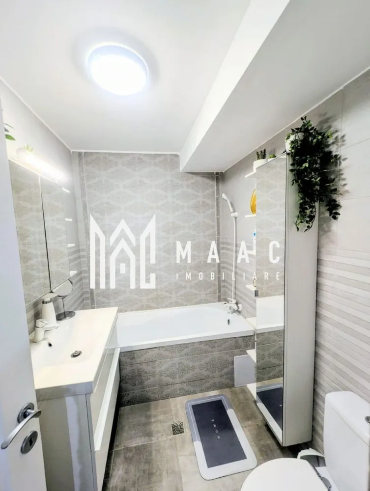 Apartament 2 Camere I Pod amenajat ca Birou | Finisaje Premium | Sibiu - MAAC Imobiliare vă propune spre vânzare un apartament deosebit cu 2 camere, situat în prima parte a Cartierului Arhitecților, pe strada Irina Rosetti, într-o zonă apreciată pentru accesul rapid către Sibiu, proximitatea parcului și atmosfera liniștită.

Apartamentul are o suprafață utilă de 51 mp, la care se adaugă un pod amenajat de aproximativ 25 mp, utilizat în prezent ca birou, rezultând un spațiu total extrem de funcțional și confortabil.

Compartimentare:
Living luminos
Dormitor
Bucătărie închisă
Baie
Balcon închis, izolat și încălzit, amenajat ca spațiu tehnic și depozitare
Pod/mansardă amenajată, ideală pentru birou, dormitor suplimentar sau spațiu multifuncțional

Podul a fost amenajat cu investiții serioase din partea proprietarului și beneficiază de:
Aer condiționat dedicat
Izolație foarte bună
Finisaje de calitate
Confort excelent în orice sezon

Întregul apartament a fost realizat pentru uz personal, nu pentru vânzare, motiv pentru care s-au folosit materiale și finisaje premium, cu accent pe calitate, confort și durabilitate.

Dotări:
Centrală termică proprie
Aer condiționat pe ambele niveluri
Iluminat inteligent controlabil prin telefon
Scară interioară din metal tratat și lemn de fag
Apartament foarte bine întreținut și eficient energetic

Electrocasnice incluse:
Combină frigorifică Electrolux
Mașină de spălat vase Bosch
Mașină de spălat rufe Bosch
Uscător Bosch
Televizor Sony
Plită electrică, cuptor electric și hotă cu evacuare

Se vinde complet mobilat și utilat, pregătit pentru mutare imediată.

O proprietate ideală atât pentru locuit, cât și pentru investiție, într-una dintre cele mai apreciate zone rezidențiale din apropierea Sibiului.
Pentru detalii suplimentare și programarea unei vizionări, vă rugăm să menționați la telefon numărul CP3089402.