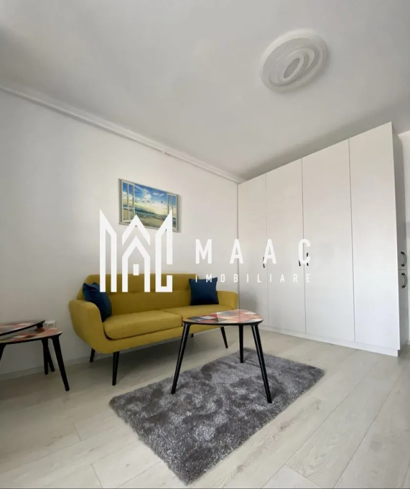Apartament 2 camere | 46 MPU | Magnolia - MAAC Imobiliare vă propune spre închiriere un apartament modern cu 2 camere, situat la etajul 8 al unui imobil nou prevăzut cu lift, amplasat în zona Magnolia din Sibiu – o locație apreciată pentru liniște, accesibilitate și dezvoltarea continuă a cartierului. Proprietatea este ideală pentru un cuplu, o persoană activă sau o familie la început de drum, oferind confort, funcționalitate și un ambient plăcut.

Apartamentul are o suprafață utilă de 48 mp și beneficiază de un balcon generos de 7 mp, perfect pentru relaxare. Locuința este complet mobilată și utilată, amenajată cu bun gust și pregătită pentru mutare imediată.

Compartimentare:
-living luminos și primitor
-dormitor confortabil
-bucătărie practică și complet utilată
-baie
-hol
-balcon spațios de 7 mp

Dotări și avantaje:
-bloc nou, bine întreținut
-etaj 8 cu lift
-apartament izolat termic
-complet mobilat și utilat
-mașină de spălat rufe
-mașină de spălat vase
-finisaje moderne și aspect îngrijit
-zonă liniștită și bine conectată
-acces facil către magazine, mijloace de transport și puncte de interes

Localizare:
Sibiu, zona Magnolia – cartier modern, apreciat pentru confort și acces rapid către oraș

Condiții de închiriere:
-garanție: echivalentul unei chirii lunare
-disponibilitate: 1 Iunie

Pentru mai multe detalii sau pentru programarea unei vizionări, vă rugăm să ne contactați specificând ID: CP3117618