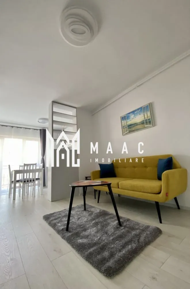 Apartament 2 camere | 46 MPU | Magnolia - MAAC Imobiliare vă propune spre închiriere un apartament modern cu 2 camere, situat la etajul 8 al unui imobil nou prevăzut cu lift, amplasat în zona Magnolia din Sibiu – o locație apreciată pentru liniște, accesibilitate și dezvoltarea continuă a cartierului. Proprietatea este ideală pentru un cuplu, o persoană activă sau o familie la început de drum, oferind confort, funcționalitate și un ambient plăcut.

Apartamentul are o suprafață utilă de 48 mp și beneficiază de un balcon generos de 7 mp, perfect pentru relaxare. Locuința este complet mobilată și utilată, amenajată cu bun gust și pregătită pentru mutare imediată.

Compartimentare:
-living luminos și primitor
-dormitor confortabil
-bucătărie practică și complet utilată
-baie
-hol
-balcon spațios de 7 mp

Dotări și avantaje:
-bloc nou, bine întreținut
-etaj 8 cu lift
-apartament izolat termic
-complet mobilat și utilat
-mașină de spălat rufe
-mașină de spălat vase
-finisaje moderne și aspect îngrijit
-zonă liniștită și bine conectată
-acces facil către magazine, mijloace de transport și puncte de interes

Localizare:
Sibiu, zona Magnolia – cartier modern, apreciat pentru confort și acces rapid către oraș

Condiții de închiriere:
-garanție: echivalentul unei chirii lunare
-disponibilitate: 1 Iunie

Pentru mai multe detalii sau pentru programarea unei vizionări, vă rugăm să ne contactați specificând ID: CP3117618