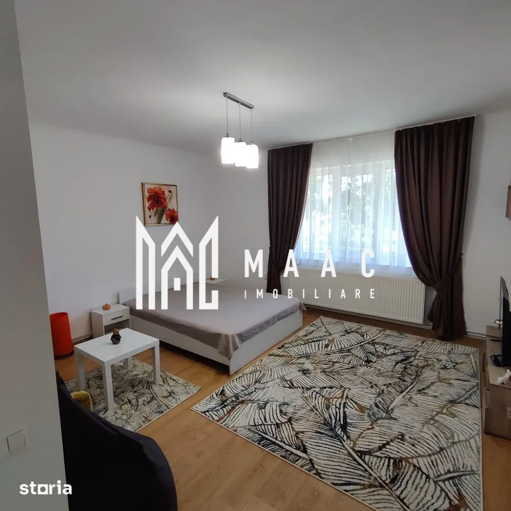 Apartament 1 camera | Etaj 1 | Decomandat | Terasa | Curte - MAAC Imobiliare vă propune spre vanzare un apartament cu o cameră, decomandat, situat la etajul 1 unei case din zona centrală (10 minute de mers pe jos de centru), mai exact pe Strada Constantin Noica.

Locuinta cuprinde: hol de acces, cameră spațioasă, bucătărie cu cămară, baie cu geam.

Garsoniera este recent renovata si mobilata, avand o suprafata toatala de 51,14 mp utili.

Aceasta este repartizata astfel: hol de 11.09 mp, camera de 23.12 mp, bucatarie de 11.27 mp, camara de 1.16 mp, baie de 4.5 mp si un balcon-terasa de 23.4 mp.

Garsoniera se afla intr-un imobil cu etaj, fiind situata la etaj unde se mai afla inca 4 familii, avand o curte comuna de 1623 mp unde se poate parca o masina (cota parte de 280mp)

Garsoniera dispune de centrala noua prin condensare, aragaz, cuptor cu microunde, cafetiera, mobila noua, TV nou, masina de spalat fiindca foarte bine pozitionata atat raportata la Facultatea de Medicina cat si in apropiere de centru ( 2 minute de mers pe jos pana in Piata Mare-Sibiu ).

Instalația electrică este refăcută integral, instalația sanitară la fel, geamurile sunt de termopan iar pereții beneficiază de izolație de 10 cm

Acoperișul este schimbat complet de 5 ani.În pod se beneficiază de spațiul conform amprentei apartamentului, având posibilitatea de mansardare.

Designul modern si ambientul placut imprima locatiei o energie pozitiva si un aer calm, intim.

În imediata apropiere se află centre comerciale, instituții de învățământ, bancare, mijloace de transport în comun.

In imobil se poate muta imediat sau se poate transforma în regim hotelier, având potențial maxim datorită poziționării centrale cât și a curții disponibile.

Pentru mai multe detalii, precizați telefonic că ați văzut anunțul cu ID: CP3117932.