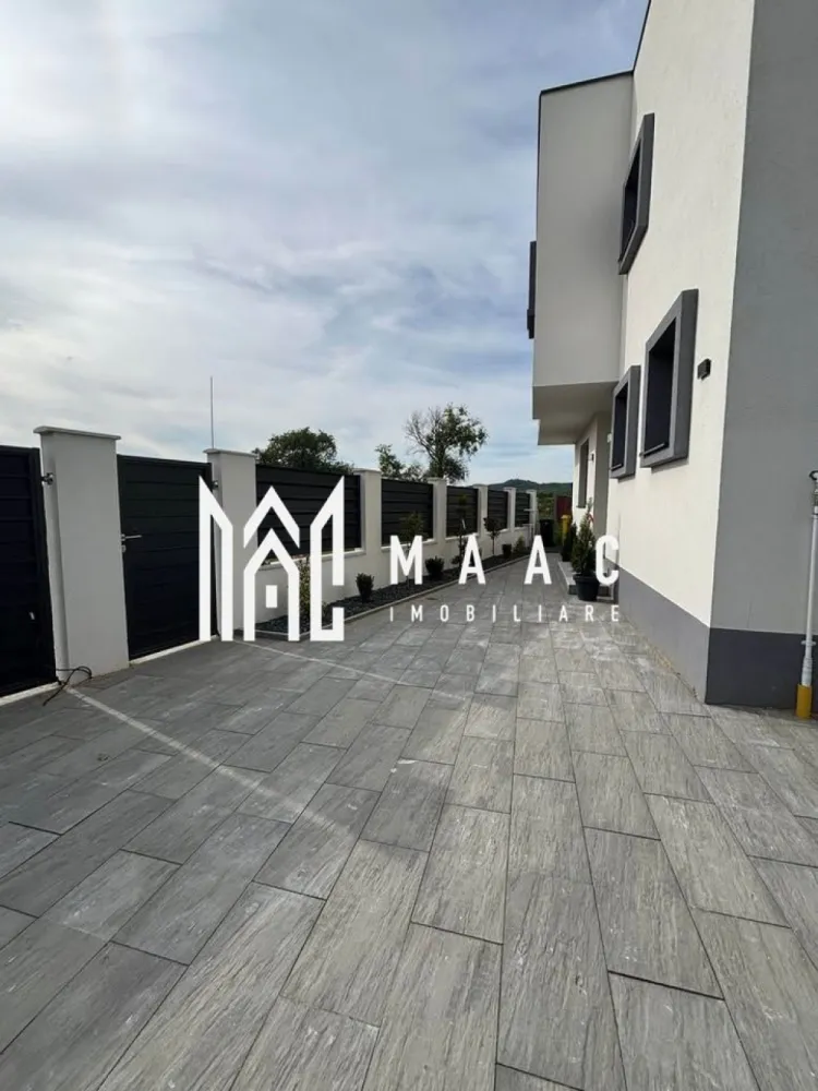 Casa Individuala I 4 camere I 350 MP Teren I Bungard - MAAC Imobiliare vă propune spre vânzare o casă individuală nouă, situată în Bungard, la doar 15 minute de centrul Sibiului.

Proprietatea este amplasată pe un teren de 350 mp și oferă o suprafață generoasă, fiind ideală pentru o familie care își dorește confort, spațiu și liniște.

Compartimentare și dotări:

4 camere luminoase și bine compartimentate;
3 băi;
Balcon;
Terasă acoperită de 40 mp;
Încălzire în pardoseală atât la parter, cât și la etaj;
Centrală termică pe gaz;
Tâmplărie PVC Salamander cu 3 foi de sticlă;
Izolație exterioară cu polistiren de 15 cm;
Construcție din cărămidă, regim de înălțime P+1.

Utilități disponibile:

Apă curentă;
Canalizare;
Energie electrică;
Gaz;
Internet și cablu TV.

Exterior:

Curte amenajată cu dale și spațiu verde;
2 locuri de parcare;
Acces direct din drum asfaltat.

Dacă sunteți în căutarea unei locuințe noi, bine construite și amplasate într-o zonă cu acces facil către oraș, această proprietate merită vizionată.

Pentru mai multe detalii sau pentru programarea unei vizionări, vă stăm cu drag la dispoziție. Cod anunț CP3089203 .Contactați-ne pentru o vizionare și pentru informații suplimentare.