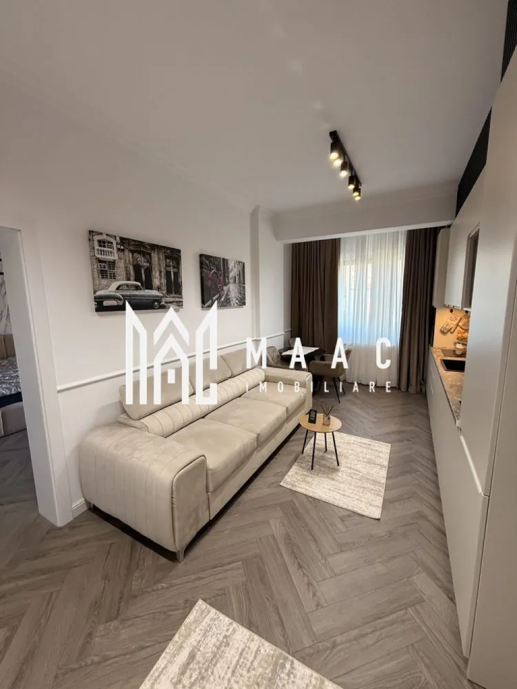 Apartament 3 camere decomandat | Hipodrom 4, Sibiu | 75 mp, lift, 2024 - Apartament cu 3 camere decomandat, situat în zona Hipodrom 4 - Cireșica din Sibiu, cu 75 mp utili, într-un imobil finalizat în 2024, dotat cu lift și pregătit pentru închiriere.

Detalii proprietate:
• Suprafață utilă: 75 mp
• Compartimentare: living, 2 dormitoare, bucătărie, baie și hol
• Etaj 1 din 5
• Imobil finalizat în 2024, construcție din cărămidă
• Complet mobilat și utilat
• Lift în imobil
• 2 locuri de parcare supraterane incluse

Zona oferă acces la școli, grădinițe, transport public, magazine, supermarketuri și conexiune rapidă către centrul orașului, ceea ce face proprietatea practică pentru locuire de zi cu zi.

Pentru detalii suplimentare și programarea unei vizionări, contactați echipa MAAC Imobiliare și menționați Cod anunț CP3189071.
