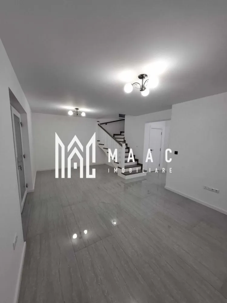 Casă 4 Camere | Prima Închiriere | Cisnădie - MAAC Imobiliare vă propune spre închiriere o casă, construită în anul 2025, situată în Cisnădie, într-o zonă bine poziționată, cu acces rapid către Sibiu, autostradă și principalele centre comerciale din zonă. Compartimentare • living / sufragerie spațioasă • 3 dormitoare • bucătărie separată • cameră tehnică • 3 băi • pod pentru depozitare Casa dispune de curte pavată de aproximativ 100 mp, oferind spațiu pentru relaxare sau parcare. Dotări și avantaje • încălzire în pardoseală atât la parter, cât și la mansardă • centrală termică pe gaz • băi complet mobilate • bucătărie complet mobilată și utilată • acces rapid către magazinele mari din Cisnădie și Sibiu • legătură rapidă cu autostrada Proprietatea oferă confort modern și eficiență energetică, fiind pregătită pentru mutare imediată. Pentru mai multe detalii sau pentru programarea unei vizionări, vă rugăm să ne contactați și să menționați ID-ul proprietății: CP2966831. }}