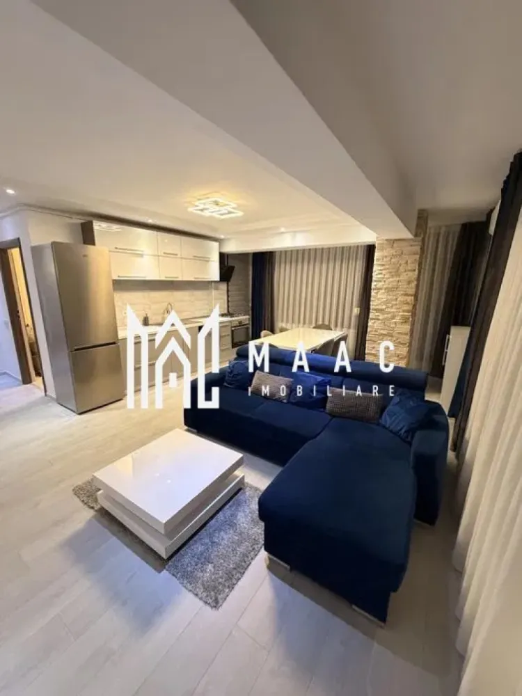 Apartament 2 camere | Șelimbăr – Doamna Stanca | Lângă Kaufland - MAAC Imobiliare vă propune spre închiriere un apartament modern cu 2 camere, situat în Șelimbăr, pe strada Doamna Stanca, într-un complex rezidențial apreciat, aflat în imediata apropiere a Kaufland Șelimbăr și la doar câteva minute de Shopping City Sibiu. Locuința are o suprafață utilă de 58 mp (exclus balcon) și este compartimentată eficient, oferind un spațiu bine organizat: living open space cu bucătărie complet echipată dormitor spațios baie modernă, dotată cu duș walk-in Apartamentul este complet mobilat și utilat cu mobilier modern și electrocasnice de calitate, fiind pregătit pentru mutare imediată. Printre dotări se numără: mașină de spălat rufe cu uscător (LG 2 în 1) mașină de spălat vase frigider, aragaz și cuptor aer condiționat televizoare în fiecare cameră finisaje premium (parchet, gresie, faianță tip mozaic) Imobilul dispune de locuri de parcare în regim „primul venit – primul servit”, însă locul de parcare nu este inclus în prețul chiriei. Condiții de închiriere: nu se acceptă animale de companie disponibilitate imediata. Pentru mai multe detalii și programarea unei vizionări, vă invităm să ne contactați, menționând ID-ul ofertei:CP2978046 }}