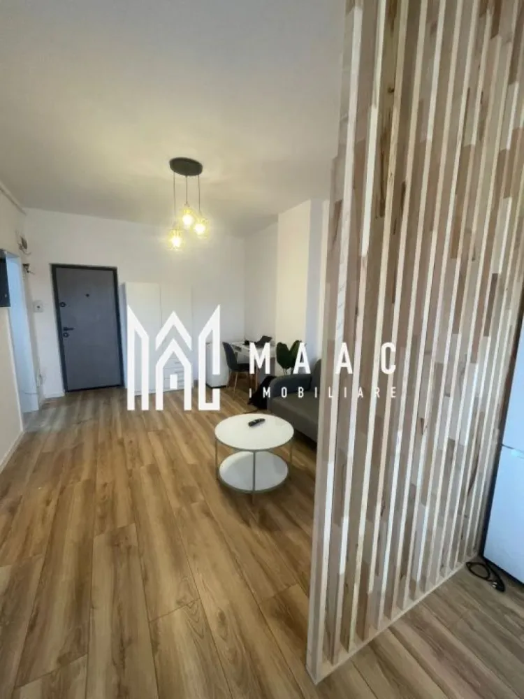 Apartament 2 camere | Modern | Lift | Parcare | Etaj 2 | Turnișor - Maac Imobiliare prezintă spre închiriere un apartament modern cu 2 camere, situat în cartierul Turnișor, într-un bloc nou dotat cu lift, la etajul 2. Cu o suprafață utilă de 50 mp, locuința este eficient compartimentată și amenajată într-un stil modern, oferind confort și funcționalitate, fiind ideală pentru un cuplu sau o persoană singură. Compartimentare: Living cu bucătărie open space Dormitor Baie cu duș walk-in Dotări și beneficii: Mobilat și utilat modern Mașină de spălat rufe TV Loc de parcare exterior inclus Bloc nou cu lift Zonă liniștită, în plină dezvoltare Apartamentul este disponibil începând cu data de 1 Mai. }}