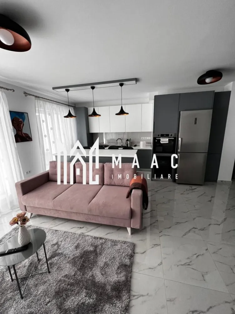 Apartament 3 camere | Terasă 12 MP | Parcare | Turnisor - MAAC Imobiliare vă propune spre închiriere un apartament modern cu 3 camere, situat într-un bloc nou din Cartierul Kogălniceanu, la doar câțiva pași de centrul orașului — o locație excelentă pentru cei care își doresc confort, eleganță și acces rapid către toate punctele de interes. Cu o suprafață utilă de 71 mp, la care se adaugă o terasă generoasă de 12 mp, proprietatea impresionează prin designul contemporan, compartimentarea inteligentă și finisajele premium. Compartimentare: living spațios open-space cu bucătărie modernă și insulă 2 dormitoare luminoase 1 baie elegant amenajată terasă spațioasă de 12 mp, ideală pentru relaxare Dotări și beneficii: încălzire în pardoseală aer condiționat electrocasnice moderne de ultimă generație frigider dedicat pentru vinuri finisaje premium mobilier premium realizat la comandă se închiriază complet mobilat și utilat loc de parcare inclus bloc nou Apartamentul este ideal pentru cei care își doresc să locuiască într-una dintre cele mai apreciate zone rezidențiale, aproape de centru, restaurante, cafenele, școli și zone de promenadă. Dacă îți dorești un apartament „la cheie”, amenajat cu bun gust și atenție la fiecare detaliu, această proprietate este alegerea perfectă. Pentru mai multe detalii și programarea unei vizionări, vă rugăm să ne contactați telefonic și să menționați CP3036052. }}