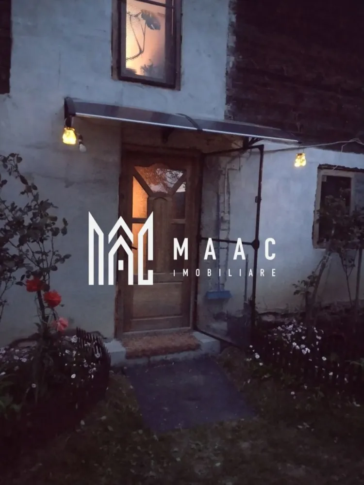 Casa Vantului si 8000 metri patrati in Abrud - MAAC Imobiliare va ofera spre vanzare la iesirea din orasul Abrud, unde munții își întind brațele către vale, se află Casa Vântului. Nu era o locuință obișnuită; era o poveste întruchipată în piatră și lemn, cu răsuflarea pământului în fiecare colț. Casa locuita de proprietari in acest moment Era compusă din două dormitoare, fiecare cu ferestre largi ce prindeau soarele dimineața și lună noaptea. Bucătăria, mică și eficientă, avea un cuptor cu lemne care pâlpâia în serile de iarnă, iar aroma de plăcinte umplea întreaga casă. Baia, simplă și curată, era locul liniștit unde apa curgea dintr-un izvor propriu. Camera, ascunsă după o ușă masivă, păstra conserve, jambale și mirodenii, păstrând proviziile pentru lungile ierni. Scările interioare, din lemn solid, duceau la holul luminat de o lampă veche, care era punctul de întâlnire al tuturor căilor din casă. Terasa, largă și acoperită, era ochiul casei spre lume, unde stăteau să privească cerul și livezile. Grajdul și Fânarul Departe de casă, dar încă în sânul proprietății, se afla grajdul. Nu era doar un loc pentru animale; era un spațiu de viață. Căluții își scuturau coamele la briza de amiază, și vacile rumega liniștit. Fânarul, înalt și umbrit, păstra iarba uscată, mirosul de summer înghețat în bălți de aur. Livezile și Pământul Livezile se întindea pe o parte a terenului de 8000 de metri pătrați – meri, peri și cireși își înălțau ramurile spre soare. În primăvară, ele se îmbrăcau în floare, iar toamna, rodul era atât de mult că se împărțea cu întreg satul. Restul pământului era o alternanță de pajiști și pădure mică, unde copacii bătrâni păstrau tăcerea veșnică a munților. Viața în Casa Vântului Aici, viața nu era măsurată în ore, ci în sezoane. Diminețile începeau cu cântecul cocoșilor, zilele erau umplute cu lucrul pământului și îngrijirea animalelor, și serile se încheiau pe terasa, sub stele. Casa nu era doar un loc de locuit; era un organism care trăia și respira cu cei care o umpleau. Fiecare cameră avea o poveste, fiecare colț păstra o amintire, și întreaga proprietate era o hartă a unei vieți simple, dar pline. În Abrud, judetul Alba, Casa Vântului nu era doar o construcție; era o parte a pământului, o bucată de istorie și un refugiu pentru sufletele care căutau liniștea și rostul în ritmurile naturale ale vieții. Așa stătea, solidă și generoasă, așteptând să împartă din caldul ei cu oricine trecea pe la ușa ei. Pentru mai multe detalii precizati telefonic ca ati vazut anuntul cu ID CP3047140. }}