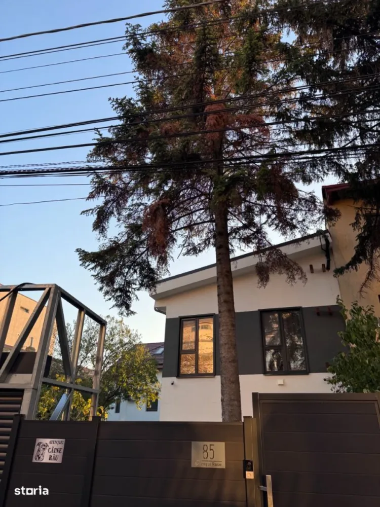 Vila verde cartier Baneasa - Casa in cartier Baneasa, conceputa pentru a deveni independenta energetic, cu aproape zero costuri de întreținere.  Finisajele premium și elementele de lux, designul modern și tehnologiile de ultimă generație, fac din aceasta o alegere ideala. Casa are dotări specifice locuințelor pasive: circuit încălzire / racire prin pardoseală conectat la pompa de căldură aer-apă, sistem centralizat de ventilație HVAC cu recuperare de căldură (momentan fara unitatea centrala), sistem SMART de climatizare si panouri fotovoltaice.     - casa pe structura metalica usoara (an finalizare 2024) - suprafata utila casa: 189mp - suprafața amprenta la sol: 95mp - suprafața totala teren:  472mp - 3 dormitoare - 3 bai ( 2 dotate cu dus walk-in și 1 cu cadă) - living open space  - bucatarie inchisa (16mp) - camera tehnica - spații de depozitare - terasa acoperita - 2 locuri de parcare (posibilitate de construcție garaj -  se poate oferi proiect + execuție)- magazie - poarta auto tip rulou automata  - pompa de caldura aer-apa Daikin - incalzire si racire in pardoseala Rehau (sistem NEA SMART climatizare)- panouri fotovoltaice 19.5 KW  (contract PPC prosumator)- curent trifazat- sistem HVAC montat la interior (fără unitatea centrala în camera tehnica)- sistem de camere supraveghere - ferestre: PVC SALAMANDER, seria bluEvolution 92 (baghete warm și precadre pentru prevenirea transferului termic)- finisaje premium: lavabila interior STO / riflaj / tencuiala decorativa interior - gresie / faianta premium (dimensiuni placi 60 x 120)- parchet premium - mobila bucatarie premium - mobila premium pe comanda (canapea / dressing + pat dormitor matrimonial)- dotari bai premium (masina de spalat haine si uscator haine)- electrocasnice - bucatarie utilata complet - dotari living (TV Samsung OLED + Soundbar JBL) - izolatie exterior polistiren grafitat expandat 15cm - izolatie interior celuloza 14cm (pereti si tavane)- folie bariera de vapori (toti peretii interiori)- rigips ignifug + rigips antiumezeala bai- tencuiala decorativa STO - acoperiș tabla click Wetterbest - usa metalica izolata cu vata bazaltica